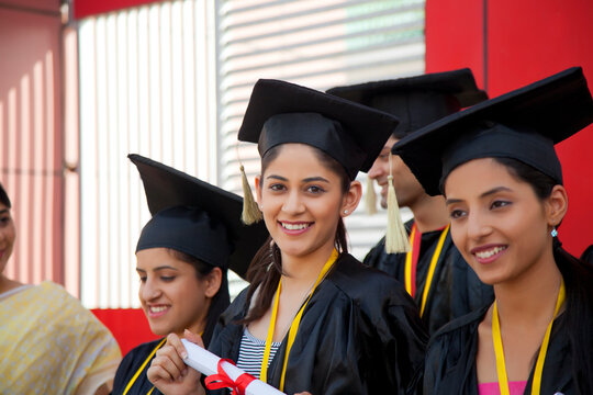 Portrait of graduate student with diploma