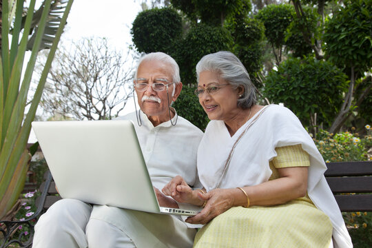 Old couple looking at a laptop