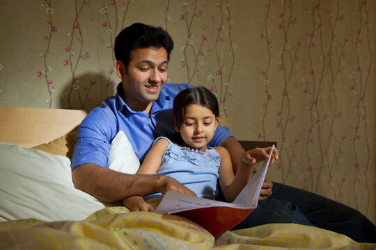 Father reading a story to his daughter