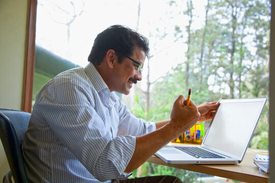 Man rejoicing in front of laptop