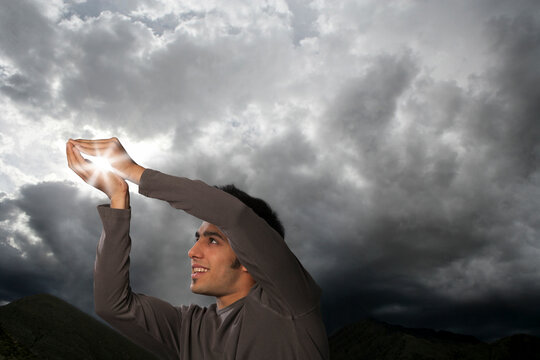 Man trying to catch sun rays