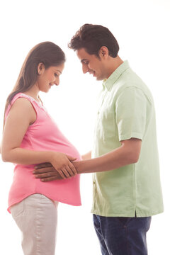 Man with hands on pregnant womans stomach