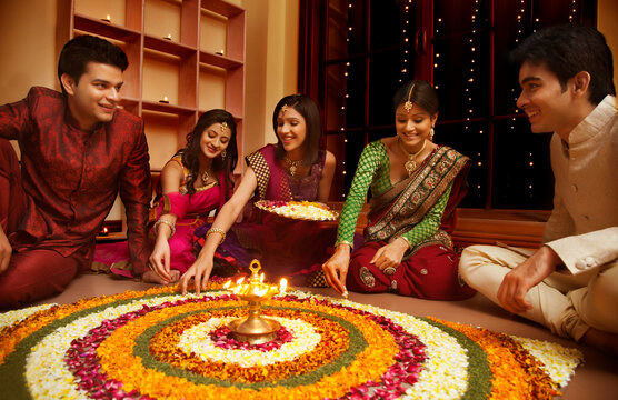 Friends making a rangoli