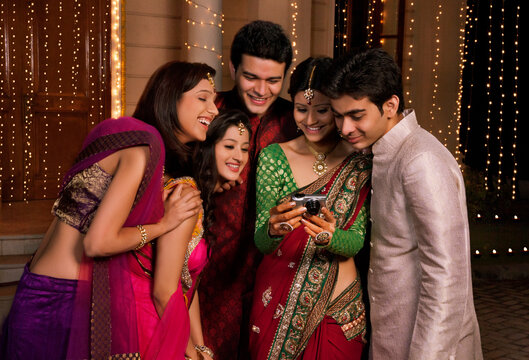 Friends looking at a picture on a camera