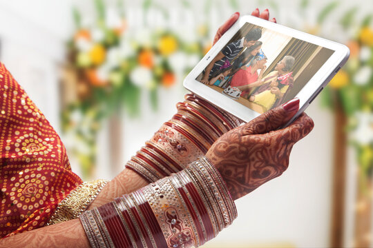 Close-up of a brides hand holding tablet computer