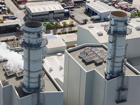 Natural Gas Fired Combined Cycle Power Plant With Tall Exhaust Stacks During Daylight