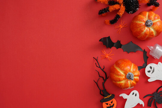 Halloween decor with pumpkins bats ghosts and spiders on red background
