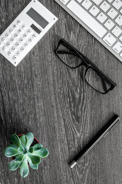 accountant or banker desk with calculator and keyboard dark wooden background top view mockup