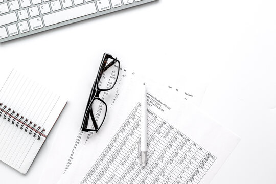 business accounter work with taxes and keyboard on white office desk top view mock up