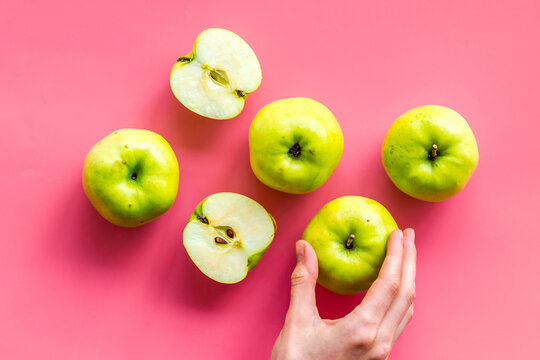 Autumn composition with green apple on pink background top view