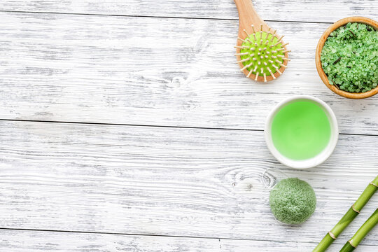 Spa composition. Natural asian spa cosmetics near bamboo on white wooden background top view copy space