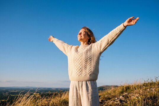 freedom-loving, happy young European woman in her twenties enjoys moment standing in sun under a cloudless sky. I love life, well-being, positive thinking, and dreaming. Walking in spring outdoors