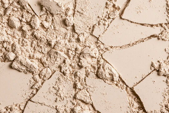 Crushed beige face foundation powder scattered macro view