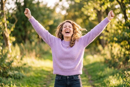 freedom-loving, happy young European woman in her twenties enjoys moment standing in sun under a cloudless sky. I love life, well-being, positive thinking, and dreaming. Walking in spring outdoors