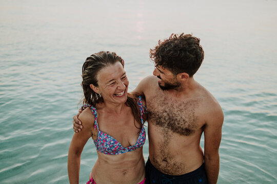 Smiling man and woman enjoy summer vacation in the sea in Ibiza