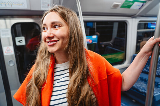 Smiling woman commutes on public transport in the city