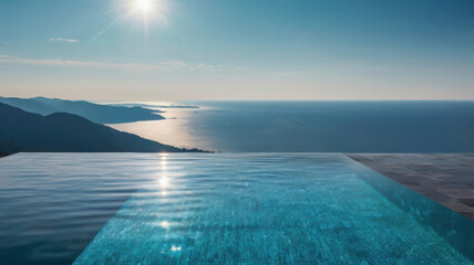 Obraz na płótnie Canvas Infinity pool overlooking sea and mountain coast under bright sun