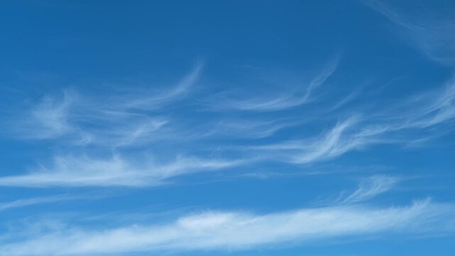 Clear blue sky with thin cirrus clouds. Natural atmospheric background with soft white streaks. Meteorological weather observation for nature environment and peaceful outdoor concept.