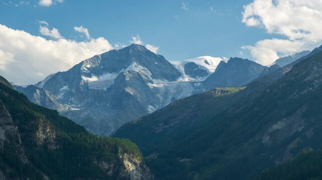 Timelapse overlooking Val d'H&eacute;rens towards Pigne d'Arolla with clouds and sunlight sweeping across the valley