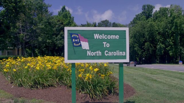 Welcome to North Carolina sign at rest area with stable video.