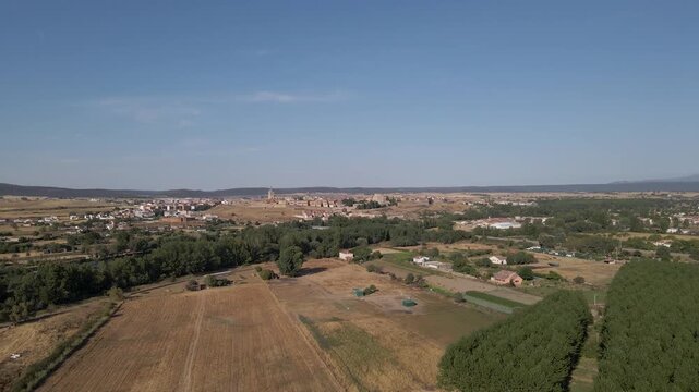 Smooth drone flyover capturing the timeless beauty of Ciudad Rodrigo with detailed views of rooftops, plazas, and medieval urban layout. Drone moving forward in direction of the city.