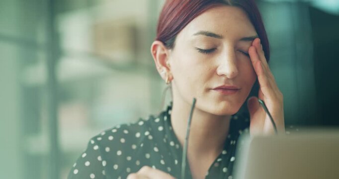 Businesswoman with eye pain in office
