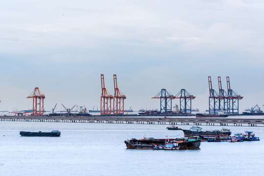 Industry landscape on sunset Engineering shipping crane depot at logistic export terminal control. Silhouette Warehouse freight background container yard loading quayside harbor port with copyspace