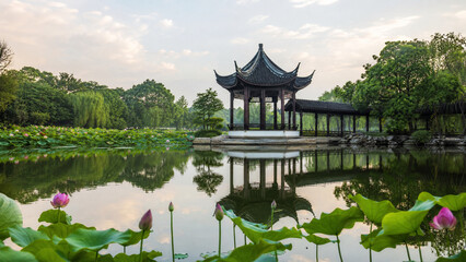 Naklejka premium Traditional Chinese pavilion in a lotus pond. Asian garden architecture at sunset.