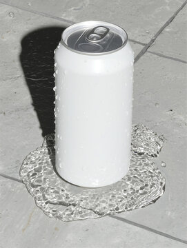 White aluminum can standing on grey stone floor with some water underneath, summer refreshing drinks concept. Soda water in a clean metal packaging.