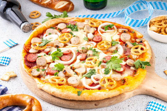 Oktoberfest Pizza with various bavarian sausages, beer and pretzels