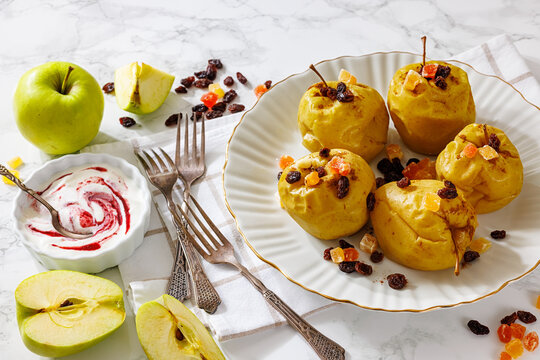 Whole Baked green apples on a white plate