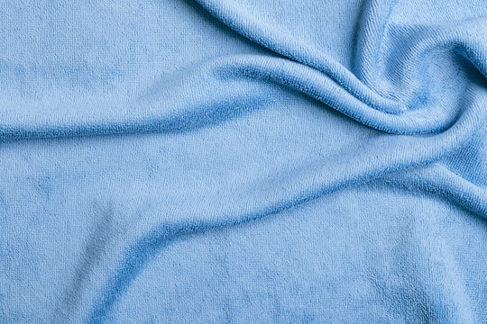 Soft Light Blue Microfiber Fabric Texture Background with Gentle Folds