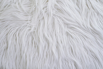 Soft white faux fur background texture with fluffy long hair fibers © Natalia