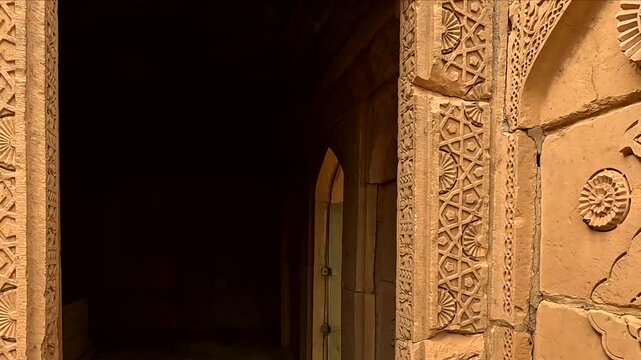 Moving Through Intricately Carved Sandstone Doorway Inside Ancient  darker