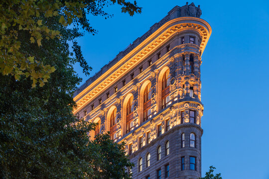 New York City, NY, USA - July 1st, 2026: Flatiron Building at dusk with newly illuminated facade. Flatiron District (Broadway and Fifth Avenue), Manhattan