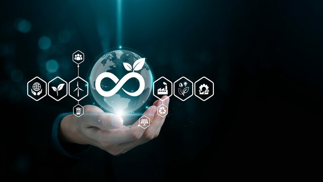 Businessman holding infinite symbol with leaf icon sustainable development goal sds renewable energy.