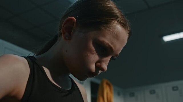 Close Up of Sweaty Young Female Performer Training Under High Pressure. Sweaty Young Athlete After Exercising Obliques and Arms With Band. Heavy Panting and Ultimate Dedication to Athletic Goals.