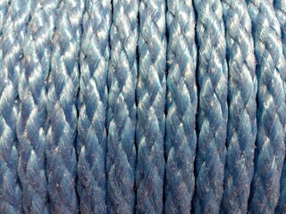 Blue braided rope texture with repeating twisted fibers © I