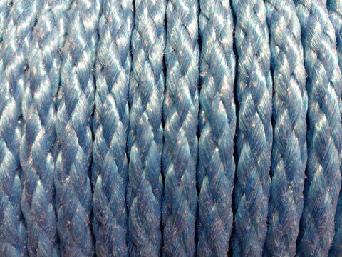 Blue braided rope texture with repeating twisted fibers