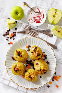 Freshly baked green apples with cinnamon, raisins