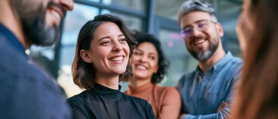 Fototapeta premium Smiling coworkers in office meeting, happy diverse team sharing ideas and friendly conversation
