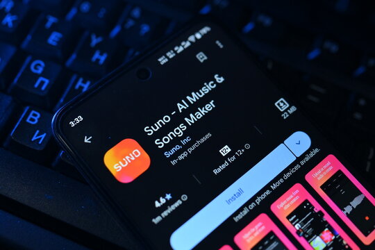 VEHARI, PAKISTAN - JULY, 30, 2026: Smartphone displaying Suno AI Music and Songs Maker app play store download page next to blue backlit computer keyboard