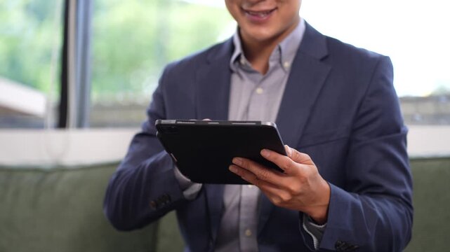 Businessman working on laptop computer with digital document, managing files data, paperless workflow, data search, cloud technology.