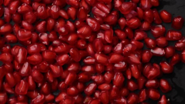 Pomegranate Arils Rotating Under Overhead Camera with Rich Red Natural Texture