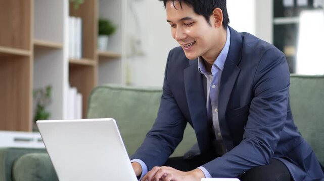 Businessman working on laptop computer with digital document, managing files data, paperless workflow, data search, cloud technology.