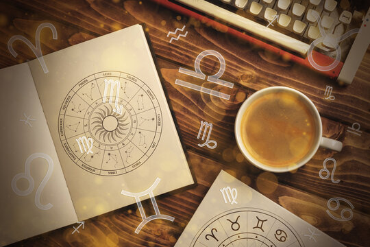 Astrology zodiac signs with a notebook and coffee on a wooden table