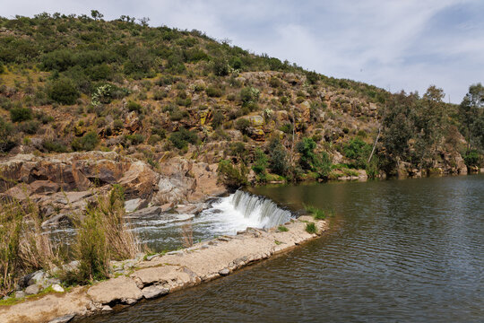 Alentejo murtega river dam creating small waterfall in spring