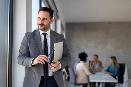 Successful executive standing proudly in office, representing business growth, partnership