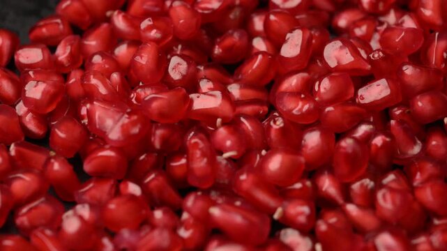 Slow Rotating Ruby Pomegranate Arils Captured from Angled Food Perspective