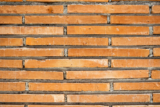 Close up texture of rustic orange brick wall